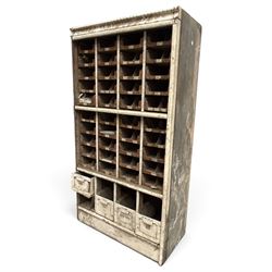 F Pollard & Co - late 19th century rustic haberdashery shop cabinet, fitted with an assortment of forty sliding trays, with drawers fitted to base, in antique white-painted finish