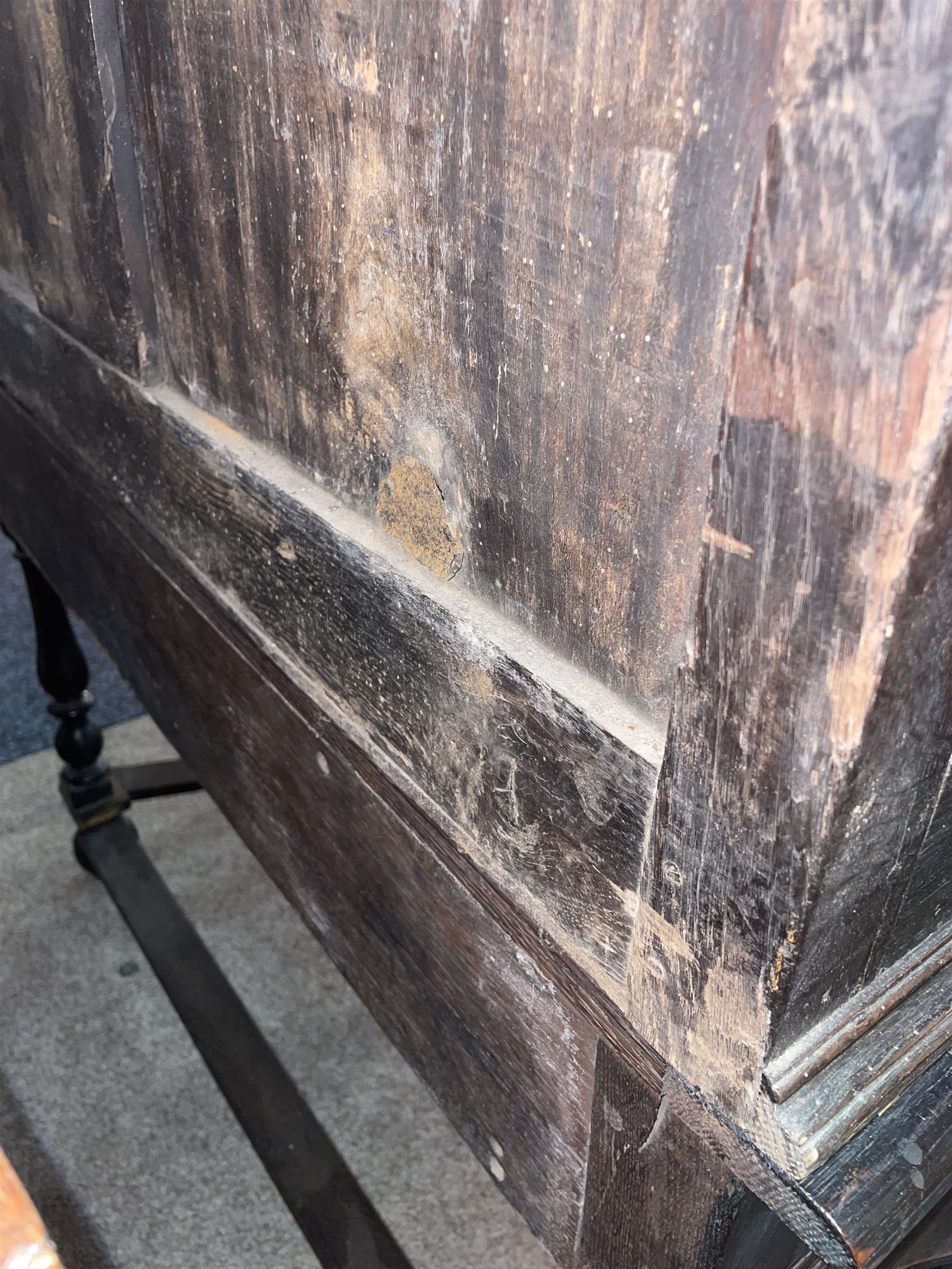 17th century oak chest on stand, moulded cornice over block work frieze, the upper section fitted with three long drawers each decorated with applied geometric mouldings and faceted panels, panelled sides with moulded frame, the stand fitted with two drawers, on five turned supports united by plan flat stretchers, terminating to turned feet