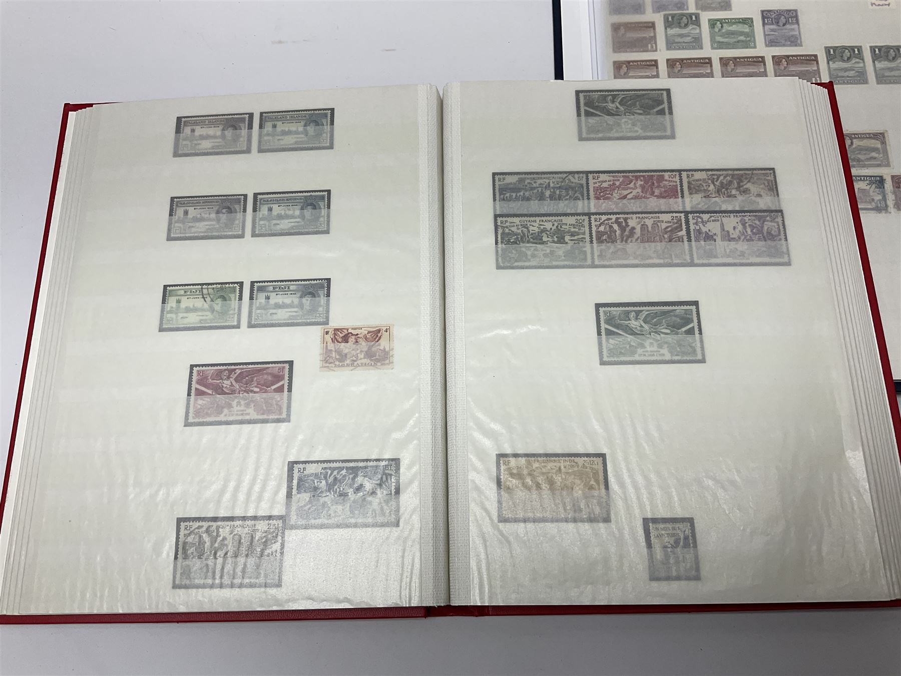 World stamps with many relating to Victory in Europe including King George VI '8th June 1946' stamps from various countries including Antigua, British Guiana, British Honduras, British Solomon Islands, Cayman Islands, Ceylon, Fiji, Grenada, Montserrat, St Helena etc, both mint and used stamps seen, housed in three stockbooks