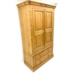Pine double wardrobe, projecting cornice, two doors above two drawers, plinth base