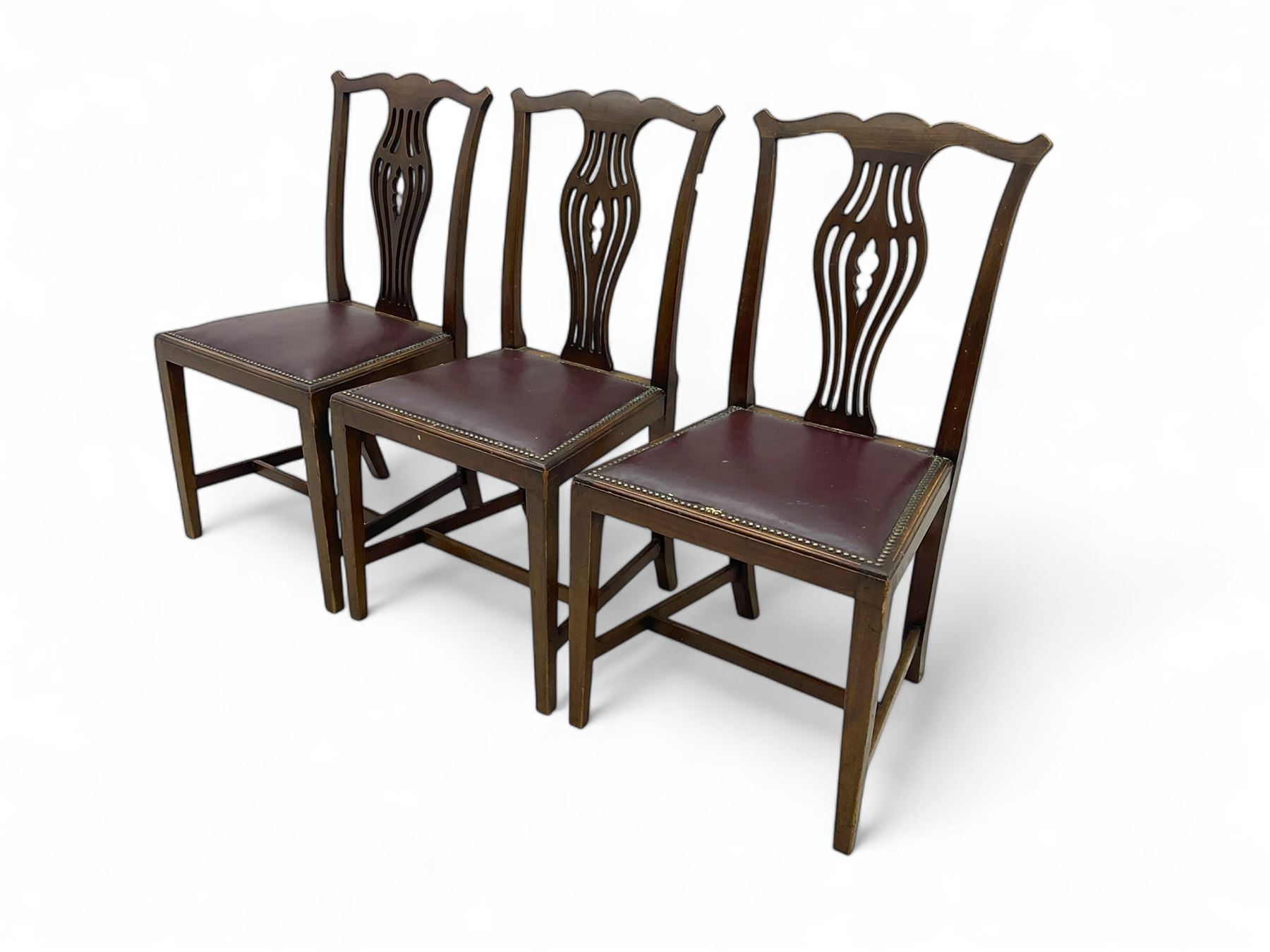 Set of six (4+2) 19th century Chippendale-design mahogany dining chairs, shaped cresting rail over pierced bulbous vase-shaped splat, burgundy leather upholstered seats with brass stud trim, on square tapering supports united by H-stretchers