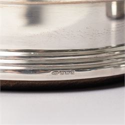 Pair of Elizabeth II silver bottle coasters with turned wooden bases D12cm, Birmingham 1994 Maker W I Broadway & Co.