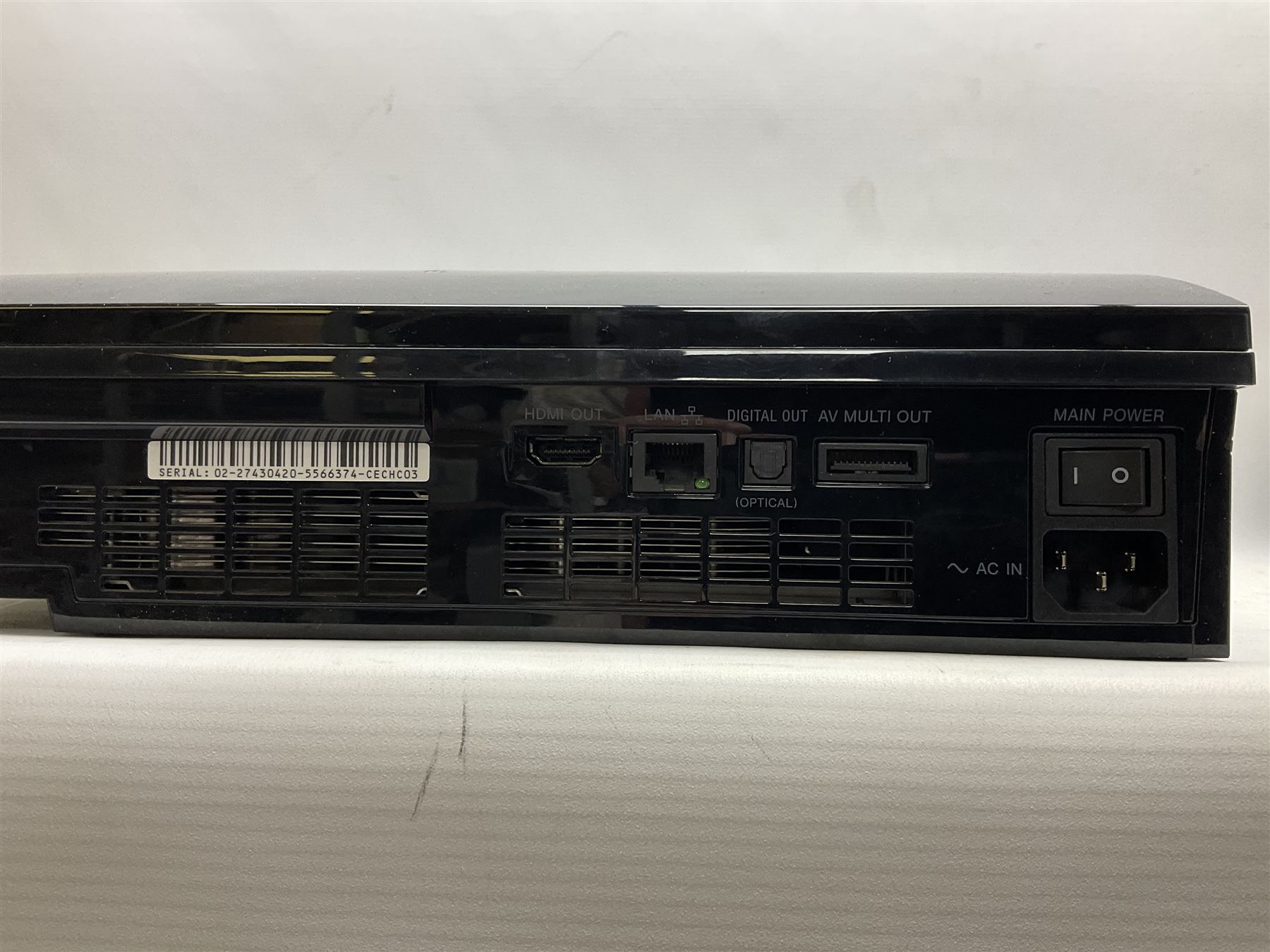 Sony PlayStation 3 60GB console with one PS3 controller, two PS2 controllers, BD remote control, PSP handheld gaming console with case, GAMEware PSP essentials pack, and a selection of PS2, PS3 and PSP games in original cases with instruction booklets 