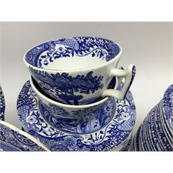 Spode blue and white Italian pattern dinner and tea wares, comprising five dinner plates, four side plates, seventeen side plates, four bowls, ten tea cups and twenty one saucers, five coffee cans and six saucers, and a flan dish, with blue and black printed marks beneath 