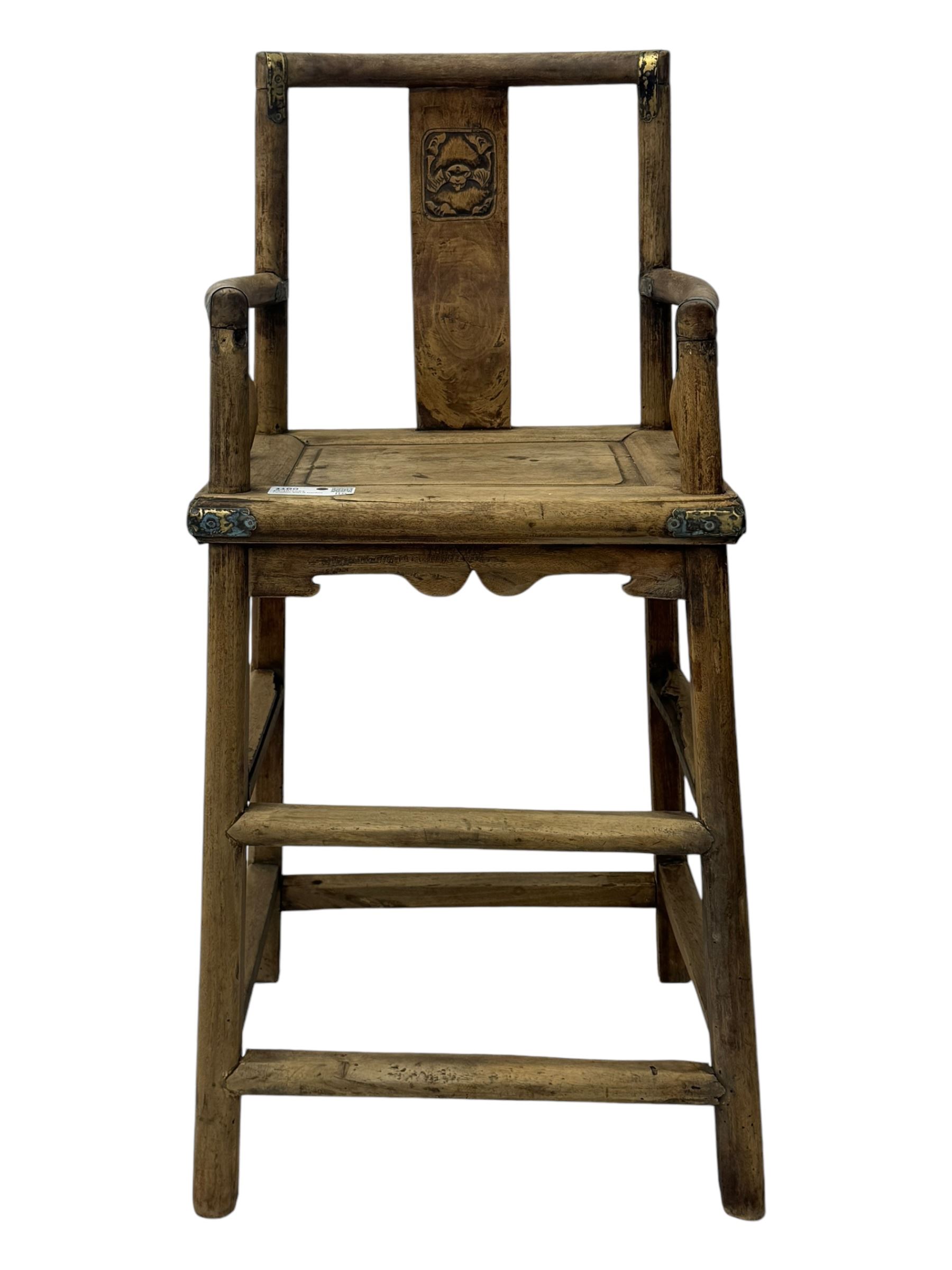 Late 19th century Chinese Qing dynasty high chair, rectangular back with central splat carved with stylised bat motif, applied brasswork to the arms and seat, on rounded supports with double stretcher