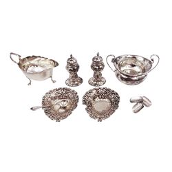 Group of silver, comprising pair of pepper shakers, bon bon dishes, milk jug, sugar bowl and spoon, all hallmarked 