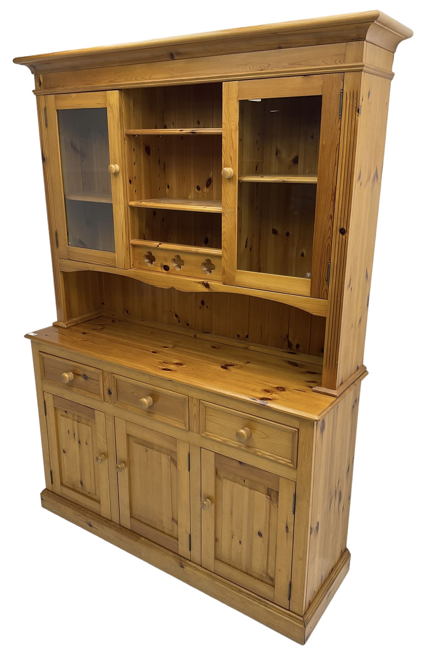 Traditional pine dresser, the rack fitted with two shelves flanked by glazed cupboards, the base with three drawers over three panelled cupboards