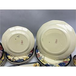 Early 20th century Art Deco Royal Doulton Pansies pattern octagonal teawares, comprising three larger teacups and saucers, three smaller teacups and saucers, open sucrier, two jugs, slop bowl, six side plates, two larger plates, two small circular dishes and one long twin handled rectangular dish, all with printed marks beneath, Rd No 597783, pattern no D4049