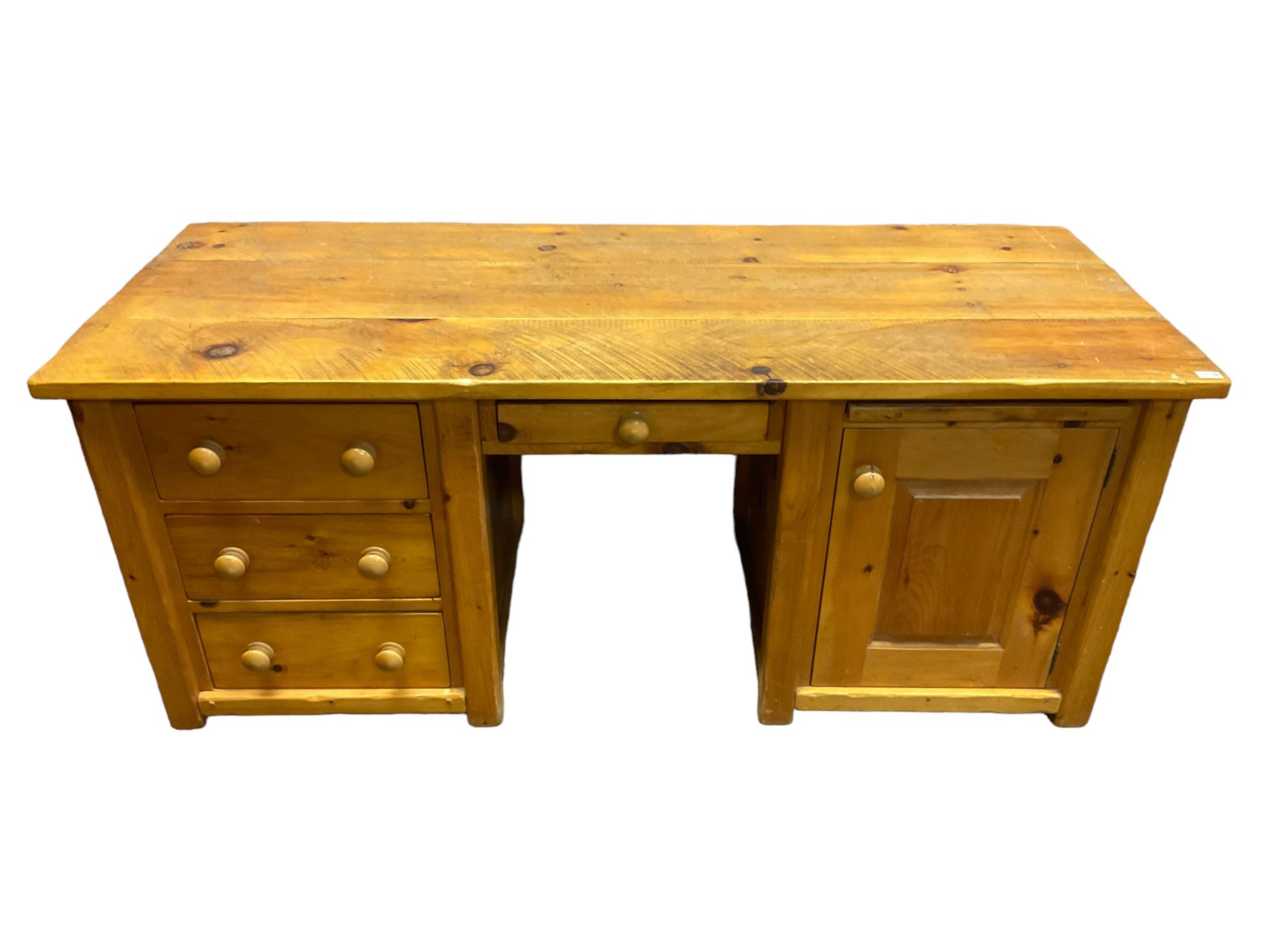 Large pine desk, rectangular top over four drawers, slide and panelled cupboard