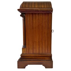 Gustav Becker, German 20th century 8-day mahogany cased mantle clock, break arch mahogany case with a round topped door flanked by reeded pilaster with Ionic capitals and raised on a stepped plinth, the dial with engraved Roman numerals, with steel fleur di Lis hands, and  chime /silent dial, H43cm