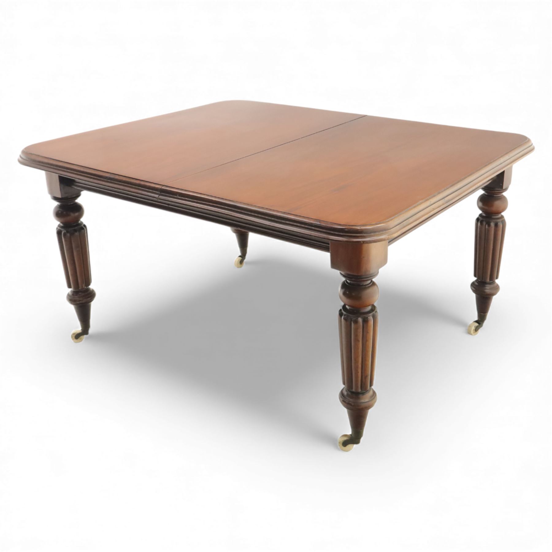 Large Victorian mahogany dining table, rectangular telescopic top with two additional leaves, upon turned knopped and reeded legs with ceramic casters, (Extends to 230cm)