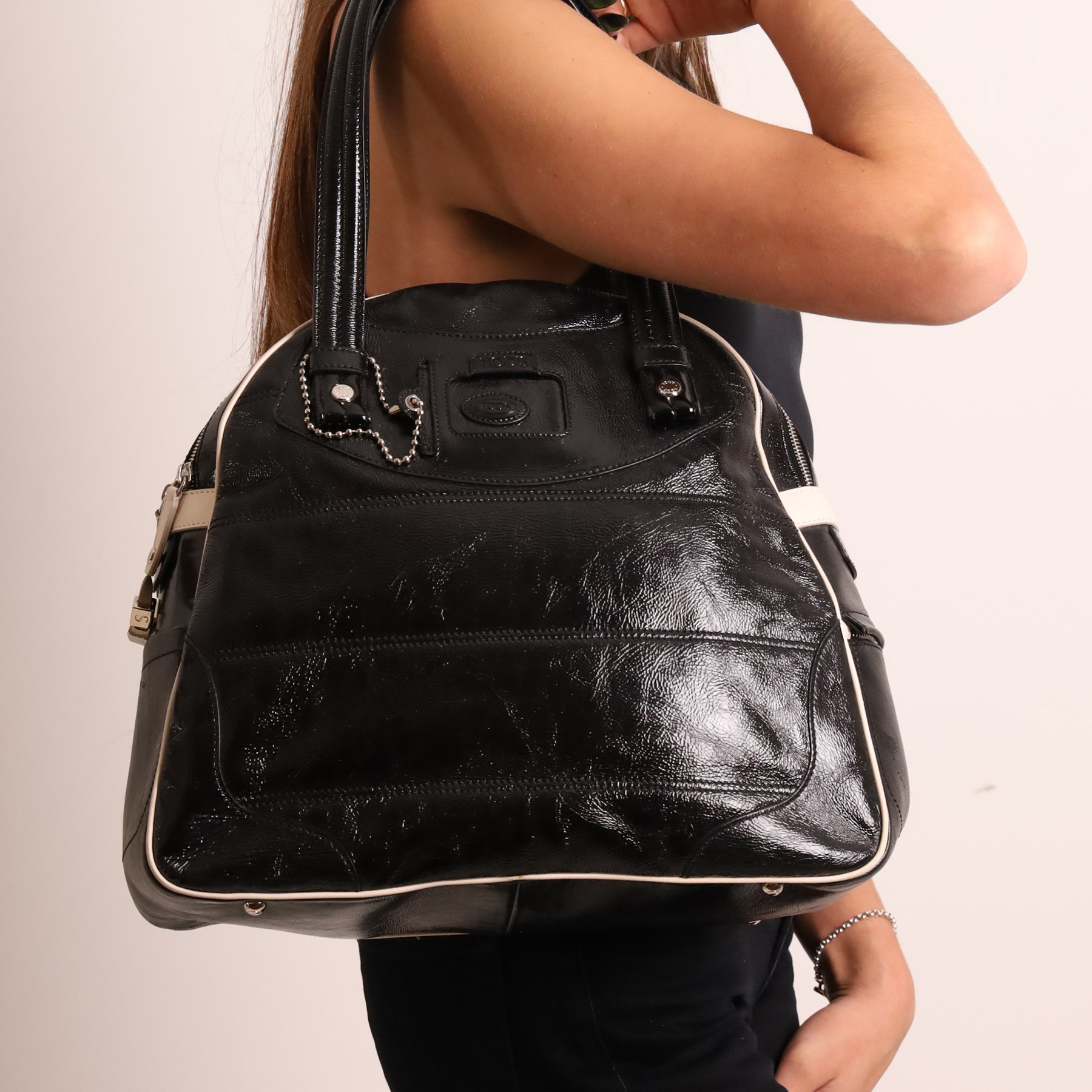 Tod’s - Tote Madis handbag in black patent leather, with twin rolled top handles, contrasting pale piping, silver-tone hardware, embossed Tod’s branding and hanging leather tag with ball-chain detail, with original Tod’s product tag and dust bag