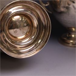 Early 20th century four piece silver tea service, comprising teapot, hot water pot, open sucrier and milk jug, all of oval bellied form with oblique gadrooned rim and upon four feet, the hotwater and teapot with wooden handles and finials, hallmarked William Lister & Sons, Sheffield 1912