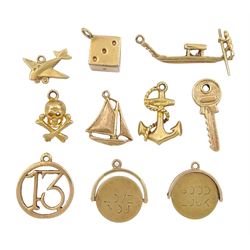 14ct gold dice charm and nine 9ct gold charms including anchor, skull and cross bones, sailing boat and two spinner I love you and good luck charms