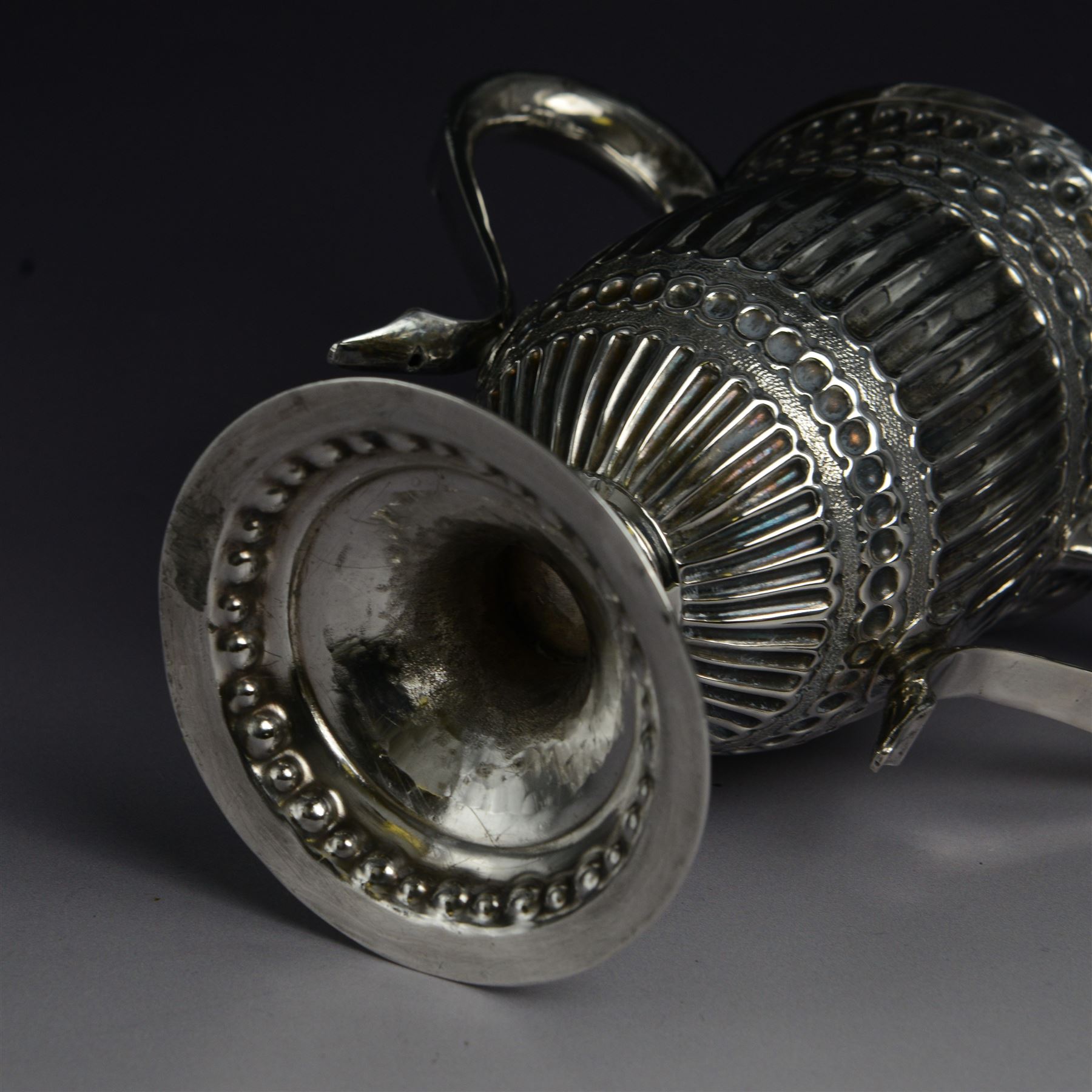 George III silver twin handled trophy cup, of typical form with twin C scroll handles and upon a domed circular foot, the body with repousse and chased fluting and C scroll decoration, with later presentation engraving to cartouche, hallmarked London 1803, maker's mark slightly rubbed but probably for Peter, Ann and William Bateman, H16cm