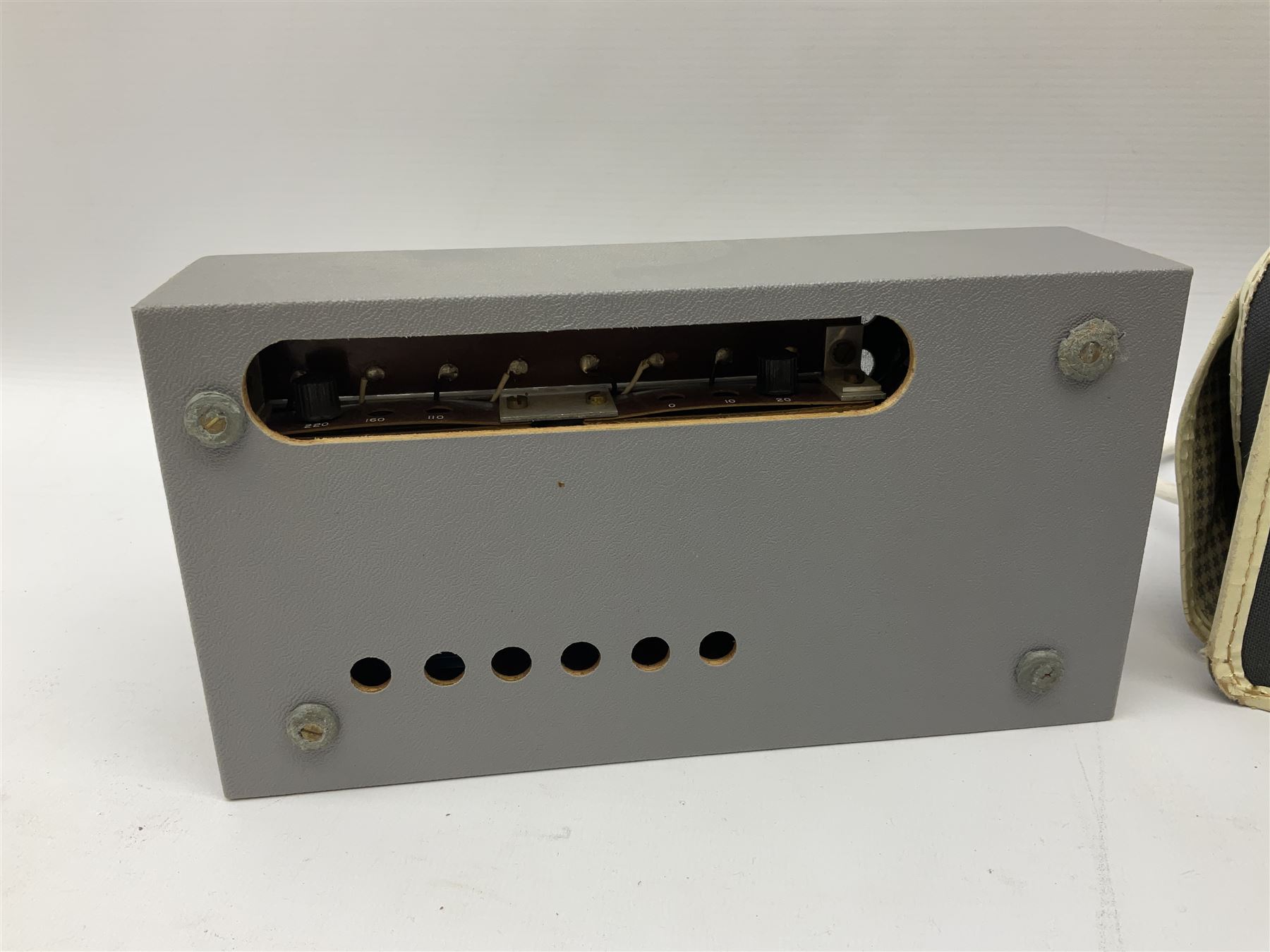 John Lennon interview recording conducted by John Hill student of Hull University on the 16th October 1964 at the A.B.C. Theatre Hull on behalf of the university newspaper 'Torchlight'. The interview lasts eight and a half minutes. It catches John in an upbeat breezy mood answering questions about the following topics: the song writing process ('sometimes you get an idea ....I dunno....my left leg.... and then write about that....'), recording (.... 'they just say - you're recording on such and such a date and they hope we turn up with some good songs written ....'), an alternative career path (.... 'I'd probably just have been a lay-about....'), failing at college (....'some other lads did my exams for me ....'), reading matter ( Clockwork Orange, Alice in Wonderland), his books of prose, tastes in music, the Blues, The Rolling Stones, being a Beatle vis-a-vis anonymity ('Whatever I'd be I'd choose to be rich .... who wants to walk down the street?').
The interview was recorded on 1/4 inch Emitape on a Fi-Cord Fidelity Recording machine. The reel-to-reel tape comes in its original Emitape plastic box and is accompanied by the Fi-Cord reel-to-reel machine on which the interview was originally recorded. Also included in this lot are a copy of the 'Torchlight' newspaper from 21st November 1964, two photographs of the interviewer with John Lennon (the interviewer is pictured to the left of John Lennon in the photograph in which John is signing a sketch) and one photograph of Paul McCartney with another reporter, the largest measures 12 x 16.5cm and a transcript of the interview. The recording is also accompanied by the original Fi-Cord tape recorder with microphone, four original 2v batteries and battery charger. The tape recorder has been adapted to take 3xAA batteries and the 2v battery charger is fitted with a standard UK 3-pin AC plug. The interview was recorded in the press room prior to the Beatles concert at the A.B.C. Theatre and is sold with copyright.