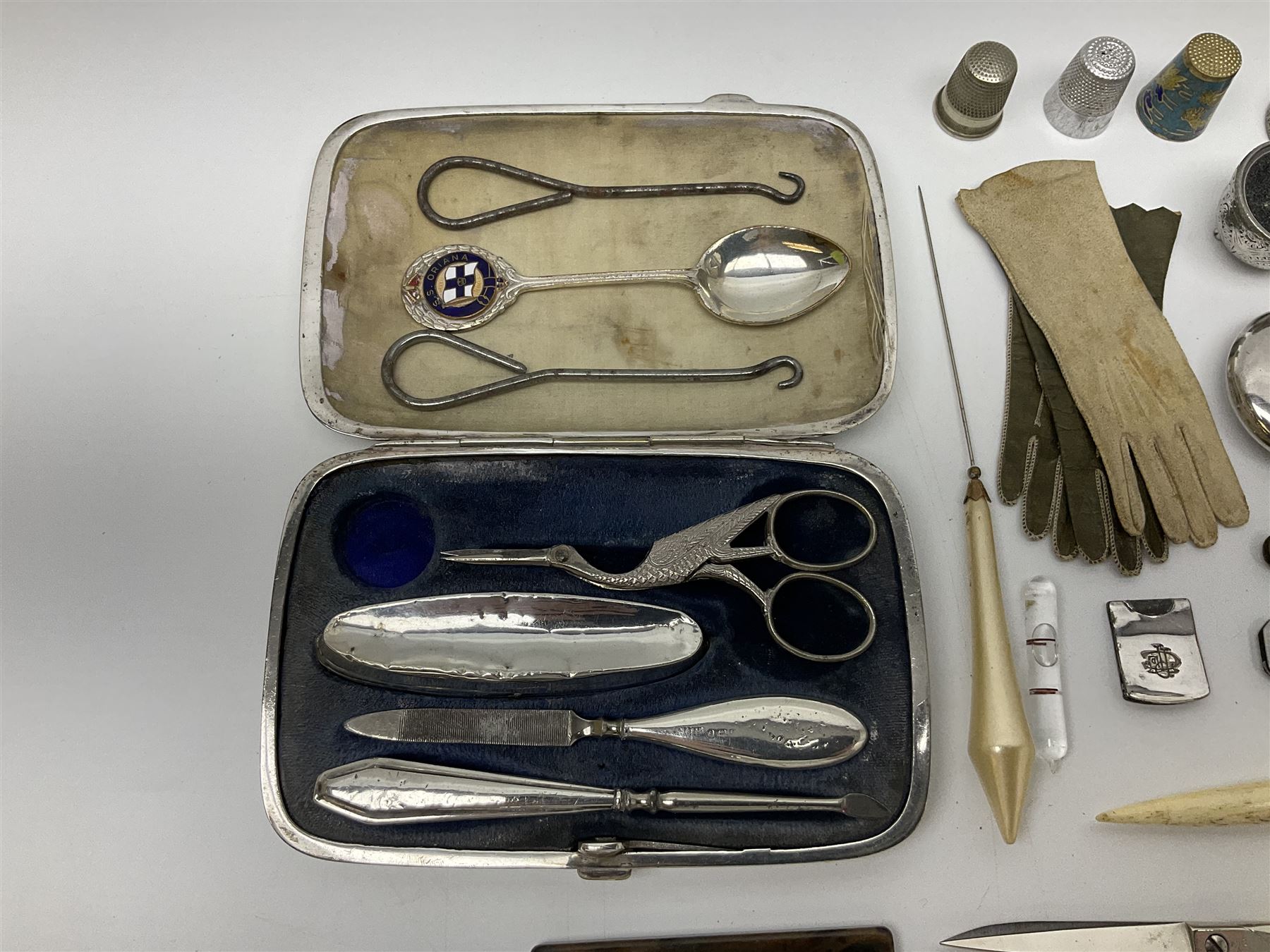 Pair of Wedgewood jasperware unicorn cufflinks, silver handled part manicure set, enamel flip notebook, dolls leather gloves, Stratton compact, and a collection of sewing accessories including thimbles, button hooks, thimble holder, scissors etc 