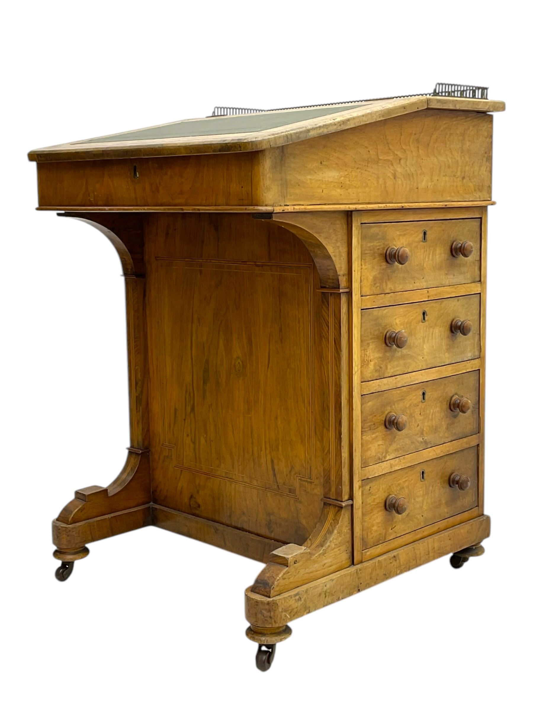 Early 19th century burr walnut Davenport desk, sloped leather-inset writing surface with brass gallery, fitted with an inkwell compartment and pen slot, four drawers to one side, raised on scrolled supports terminating in castors
