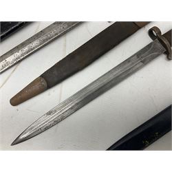 British No 7 MKI knife bayonet with 20cm single edged fullered clipped point blade;  blackened steel, large muzzle ring cross-guard; blackened swivelling pommel marked 'F5H'; red Tufnol composite grips; in blackened steel scabbard L33cm overall; British Pattern 1888 bayonet with scabbard; and German Ersatz bayonet with scabbard (3)