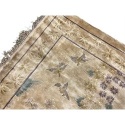 Fine Chinese silk ivory ground rug, the field decorated with birds in flight and blossom trees, the border with stylised flowers and lilac bands