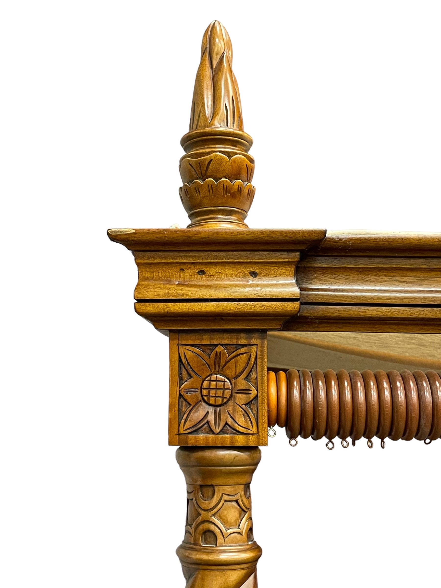 Georgian design mahogany 5' King-size four-poster bed, projecting moulded canopy top on twist-turned columns carved with acanthus leaves and flower heads, the headboard with scrolled broken swan neck pediment carved with scrolled foliage and with central anthemion, on flower head carved ball and claw front feet, with torch and foliate carved pointed finials