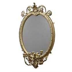  20th century ornate gilt wood and gesso framed oval mirror with three candle sconces, scrolling foliage and shell pediment, W59cm H99cm  