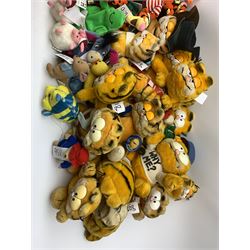 Over forty Walt Disney character soft toys including Tigger Pirate, Xmas Tree, Cowboy, Butterfly, Easter Rabbit etc, Eeyore Santa, Butterfly, Pirate etc, Piglet Lovebug, Valentine, Snowball etc; together with seventeen Garfield the Cat soft toys in various character costume including Skier, Graduate, Aviator, car rear window stickers etc