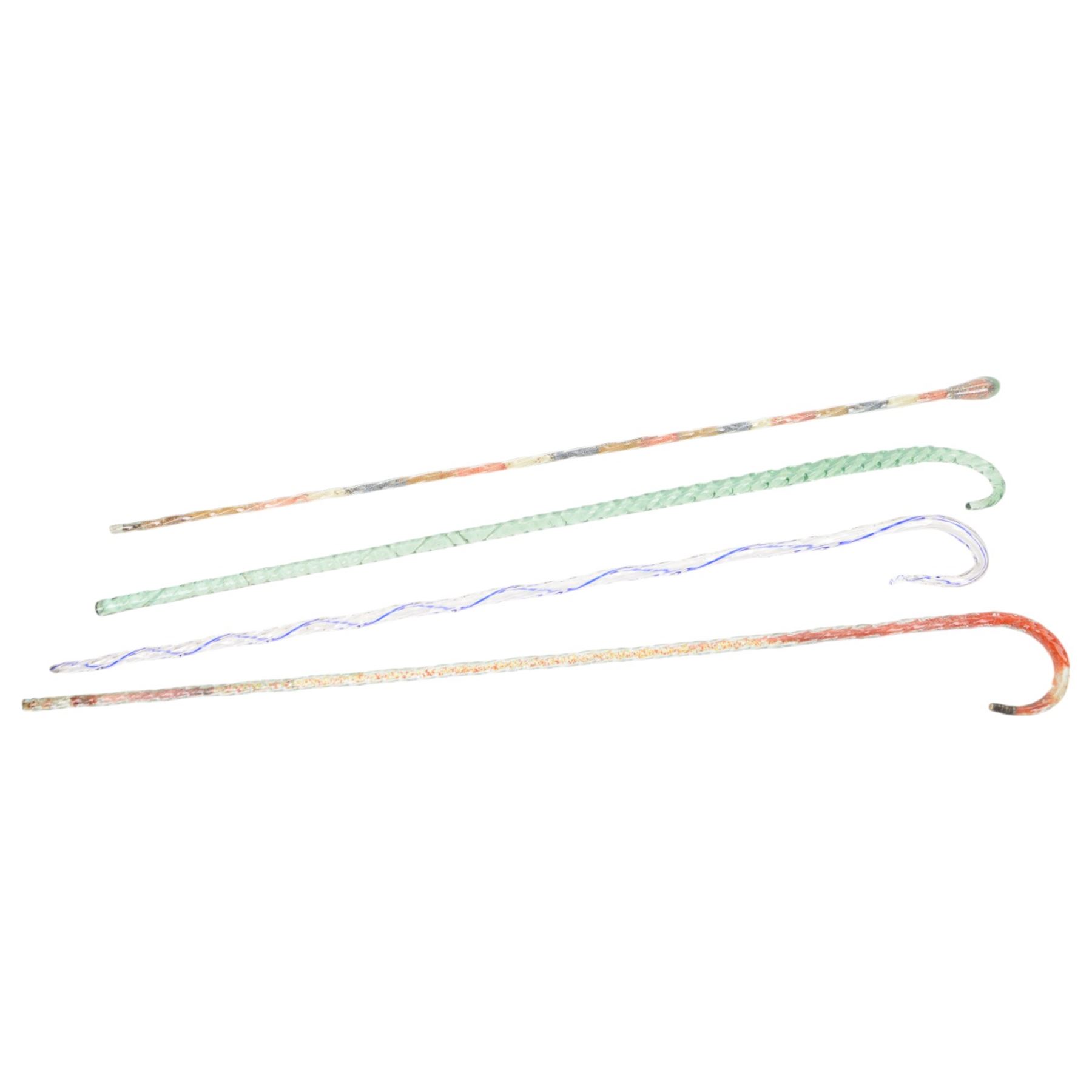 Four Victorian glass walking canes, to include two 'frigger' examples, one with blue twist design and two 'hundreds and thousands' examples, one with a knop finial and filled with micro beads, longest L105cm