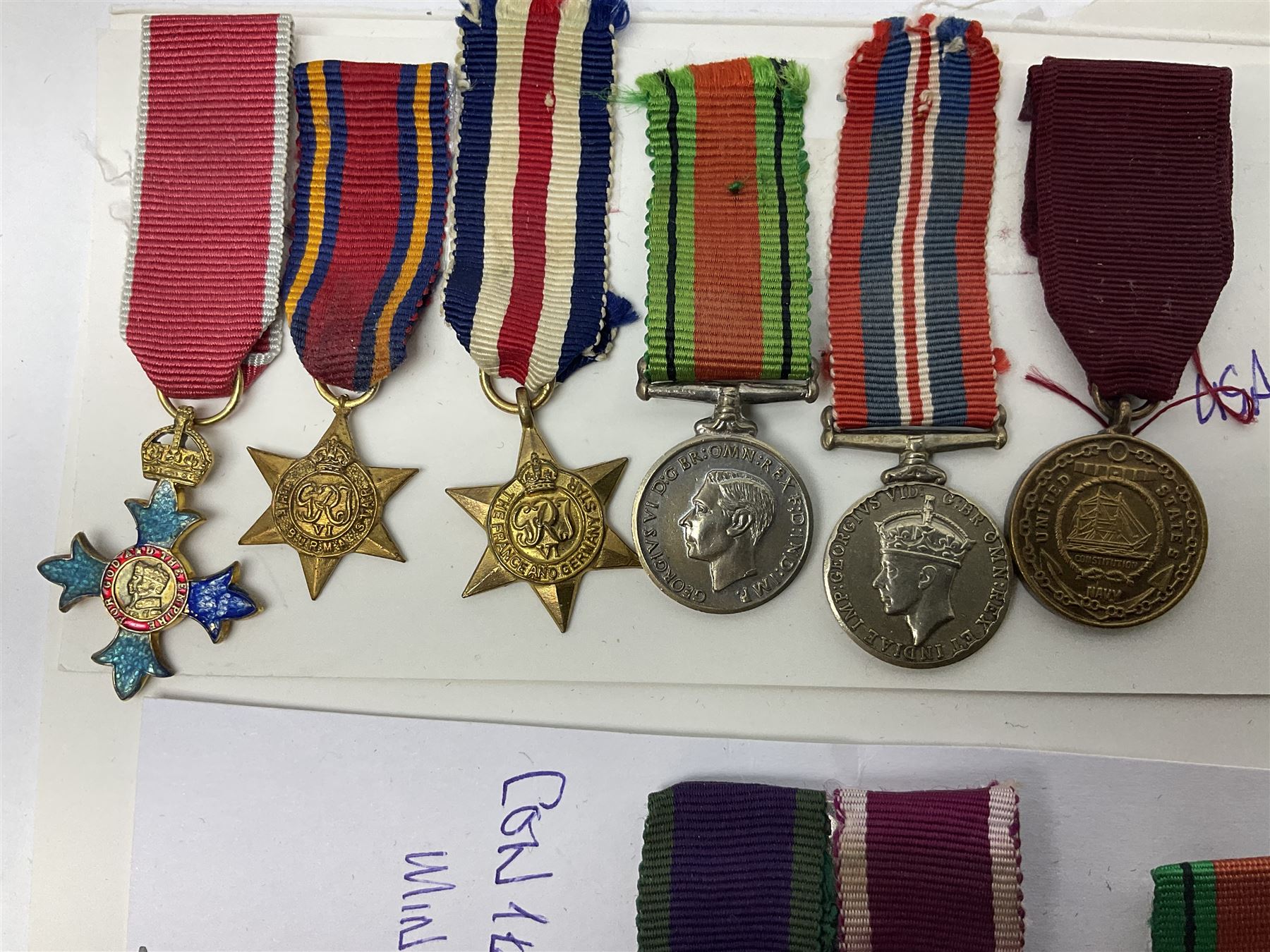 Eleven medal miniatures including Turkish Crimea, OBE (Civil), WW2 Burma Star and France/Germany Star, two pairs of WW2 War/Defence medals, LSGC etc; and two military badges