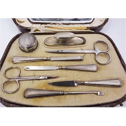 1920's silver handled manicure set including nail files, nail buffer and glass jar, hallmarked Crisford & Norris Ltd, Birmingham 1928, with later stainless steel scissors, in a crocodile skin effect case with velvet and silk mirrored interior 