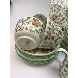 Minton Haddon Hall pattern tea wares, comprising stand, sandwich plate, oval serving dish, knife, eleven tea cups, six saucers, and three further smaller saucers, six side plates, open sucrier, and milk jug. 