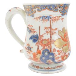Pair of 18th century Chinese export tankards, each of bellied form with curved handle and circular foot, decorated in the Imari palette with peonies, chrysanthemums and bamboo, H12.5cm