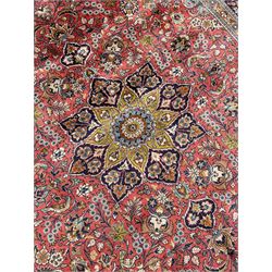 Persian Kashan peach ground rug, central rosette medallion surrounded by trailing branches and flower heads with bird motifs, light blue spandrels with further floral decoration, the main border with repeating palmettes and birds, within guard stripes