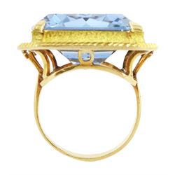 Gold synthetic spinel ring, single octagonal cut synthetic spinel with textured and engraved border