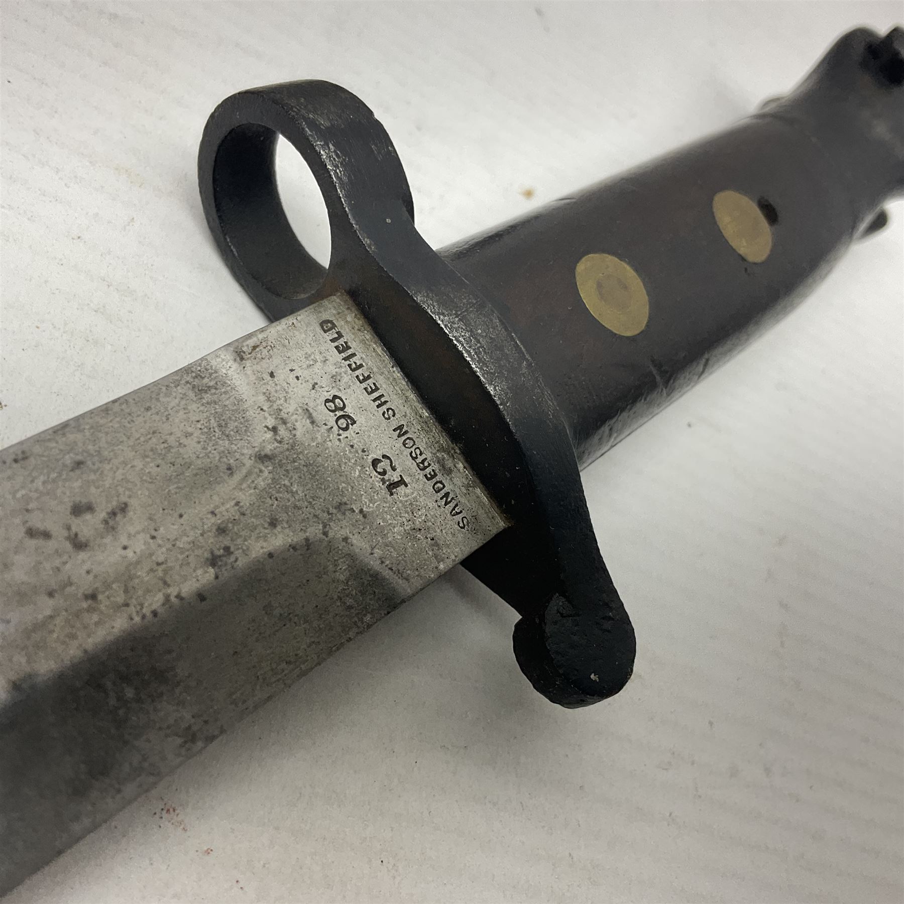 British Pattern 1888 knife bayonet, the 30cm double edged blade by Sanderson with central raised medial ridge and various marks to the ricasso including date code 12 98; in leather covered scabbard with various stamped marks L44cm overall