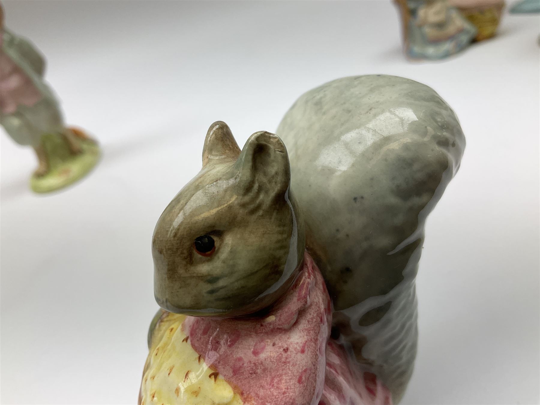 Fifteen Beswick Beatrix Potter figures, comprising Tommy Brock, The Old Woman who live in a Shoe, Samuel Whiskers, Foxy Whiskered Gentleman, Old Mr Brown, Mr Benjamin Bunny and Peter Rabbit, Tailor of Gloucester, Goody Tiptoes, Mr Benjamin Bunny, Diggory Diggory Delvet, Jemima Puddleduck, Aunt Pettitoes, Hunca Munca, Rebeccah Puddle-Duck, and Lady Mouse. 