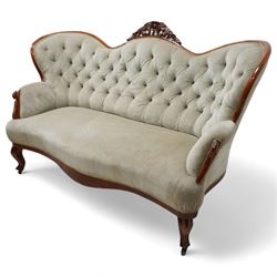 Victorian walnut double-ended settee, shaped cresting rail with foliate carved pediment, upholstered in buttoned sage green fabric, on cabriole feet