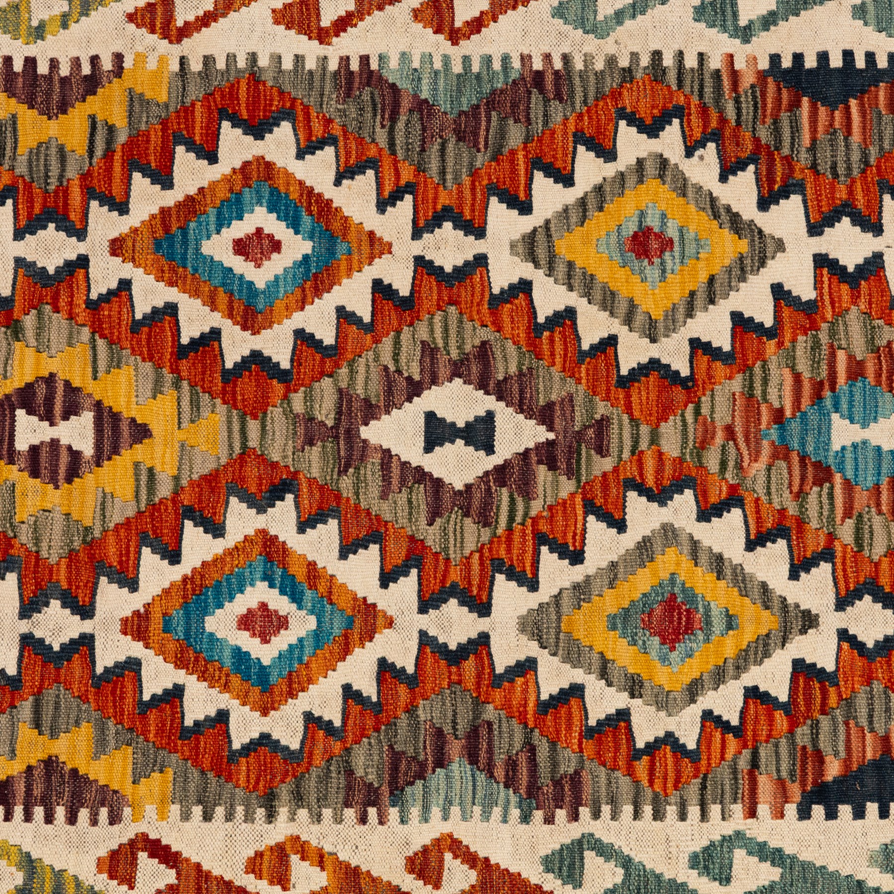 Afghan kilim ivory ground runner rug, the field with three columns of repeating lozenge motifs with amber and multicoloured tones, enclosed by a guard band decorated with repeating stylised hooks