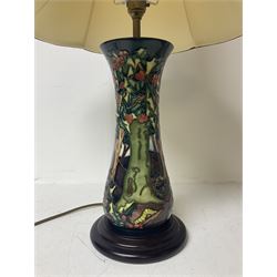 Moorcroft table lamp, of waisted form, decorated in the Holly Hatch pattern, on wooden plinth, with accompanying cream shade of lobed form, with piped detail, H33cm (excluding fitting)