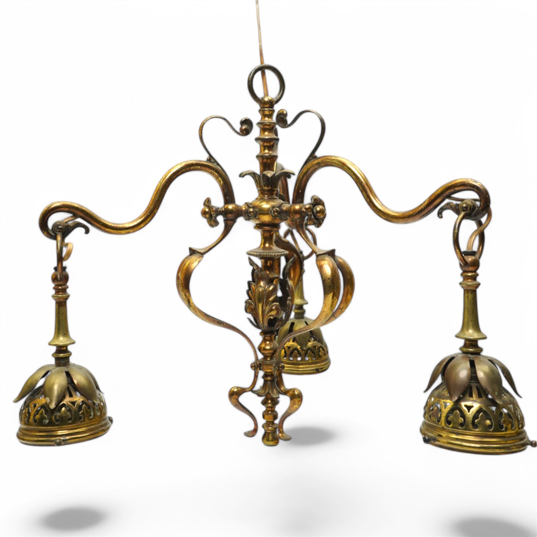 Early 20th century brass three-light chandelier, with Art Nouveau style curved and foliate ornamentation, the hanging branches formed as budding flowers with petal adornments, the bulb holders having pierced decoration to bowls, H43cm; together with two wall sconces