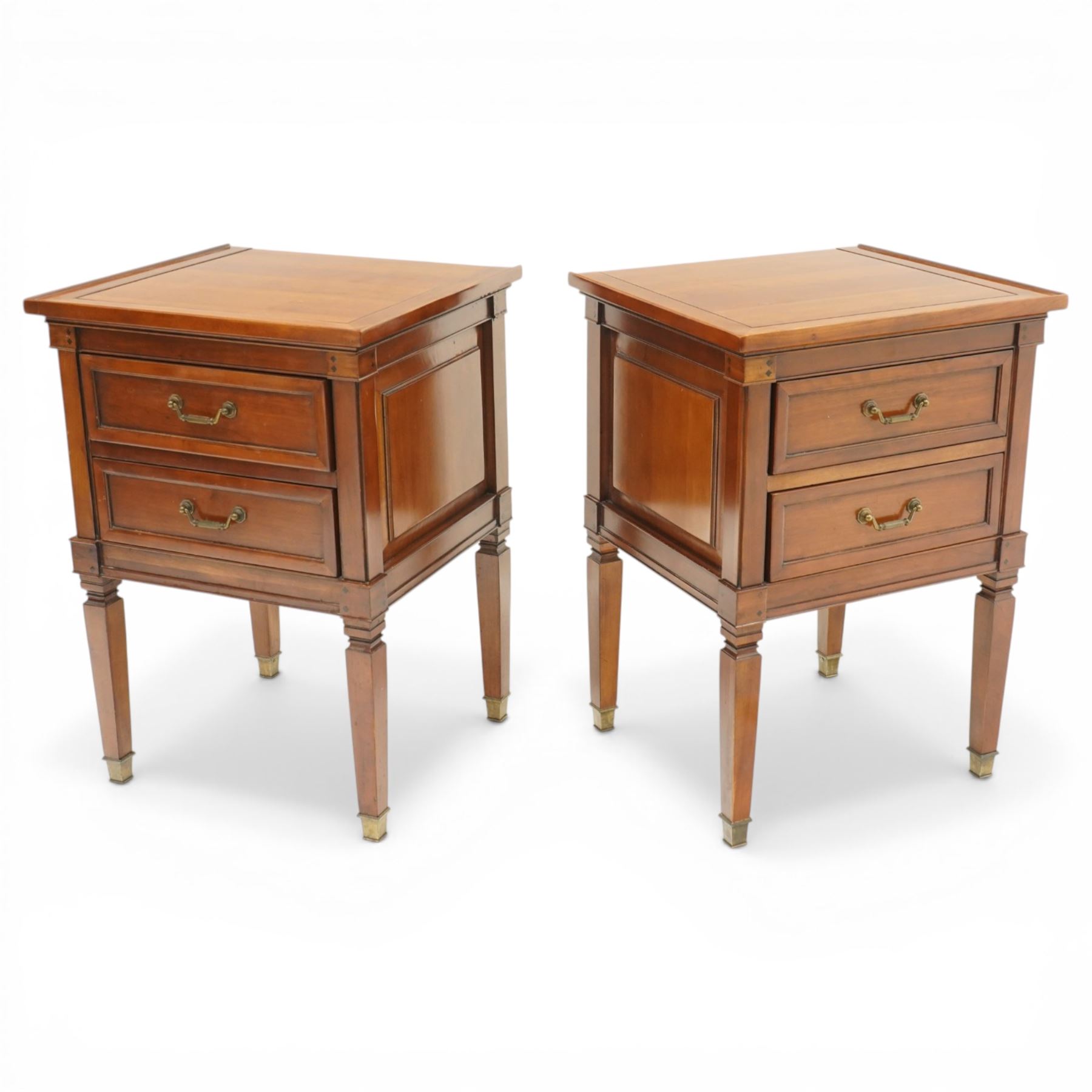 Willis & Gambier - pair of 'Directoire' cherry wood bedside tables, rectangular top with cock-beaded edge over two panelled facia drawers, raised on square turned and tapering supports on brass feet