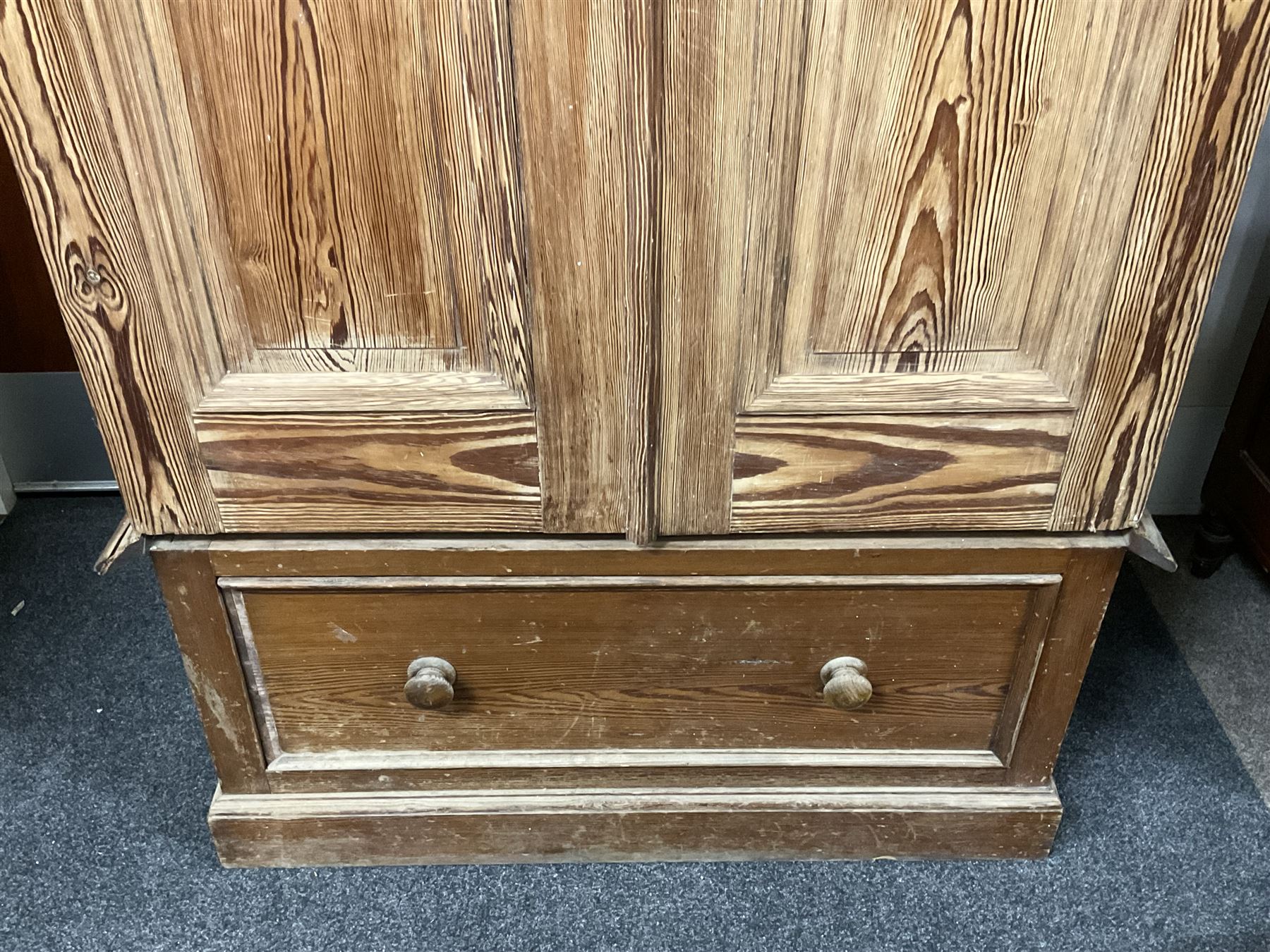 Victorian pitch pine double wardrobe, projecting moulded cornice over two panelled doors, the interior fitted with hanging rail and hooks, single drawer to base