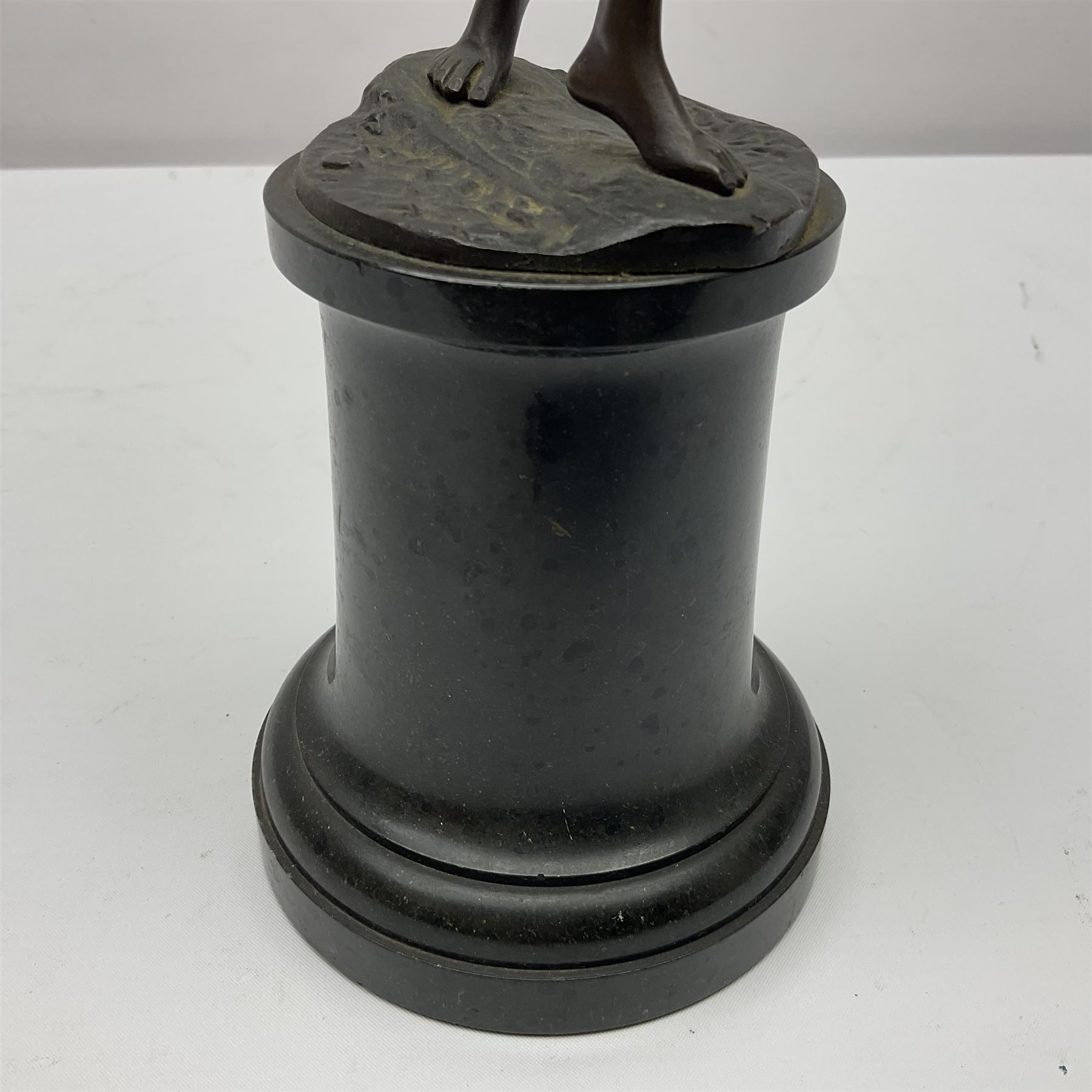 Bronze figure modelled as a nude woman with one arm raised a crescent moon upon her forehead, raised upon a circular stepped plinth, H36cm