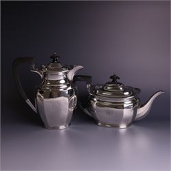 1930s silver four piece tea service, comprising teapot, hot water pot, sugar bowl and milk jug, each of part faceted oval form with engraved monogram to body, the teapot and hot water pot with Bakelite type handles and finials, hallmarked Atkin Brothers, Sheffield 1933