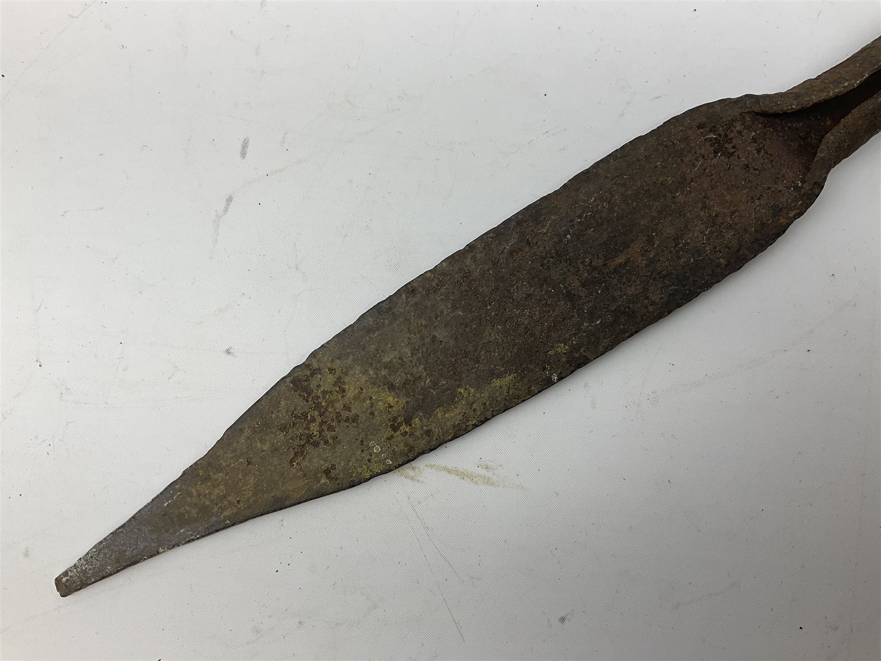 Patinated 'bronze' fantasy dagger, the 26cm blade, hilt and scabbard cast with dragons L50cm overall; hand forged iron spearhead L29.5cm; and a stiletto blade (3)