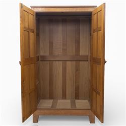Acornman - oak adzed panelled double wardrobe, with wrought iron hinges and carved oak latch revealing a single clothes rail, with signature carved acorn to top right, by the workshop of Alan Grainger, Brandsby