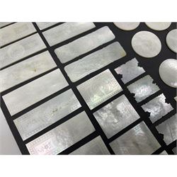 Collection of fifty seven Chinese mother of pearl gaming counters or tokens, of various size and form including rectangular, circular and fish shaped examples, various decoration including floral motifs, largest rectangular examples L6cm