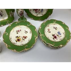 19th Century and later, Minton style tea and dessert wares, centrally decorated with a spray of flowers within green and gilt decorated borders, comprising two tea cups, saucer, three comports, one square serving dish and ten dessert plates, together with a pair of matching vases. 