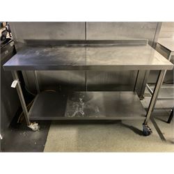 Stainless steel two tier preparation table, on castors, raised back- LOT SUBJECT TO VAT ON THE HAMMER PRICE - To be collected by appointment from The Ambassador Hotel, 36-38 Esplanade, Scarborough YO11 2AY. ALL GOODS MUST BE REMOVED BY WEDNESDAY 15TH JUNE.