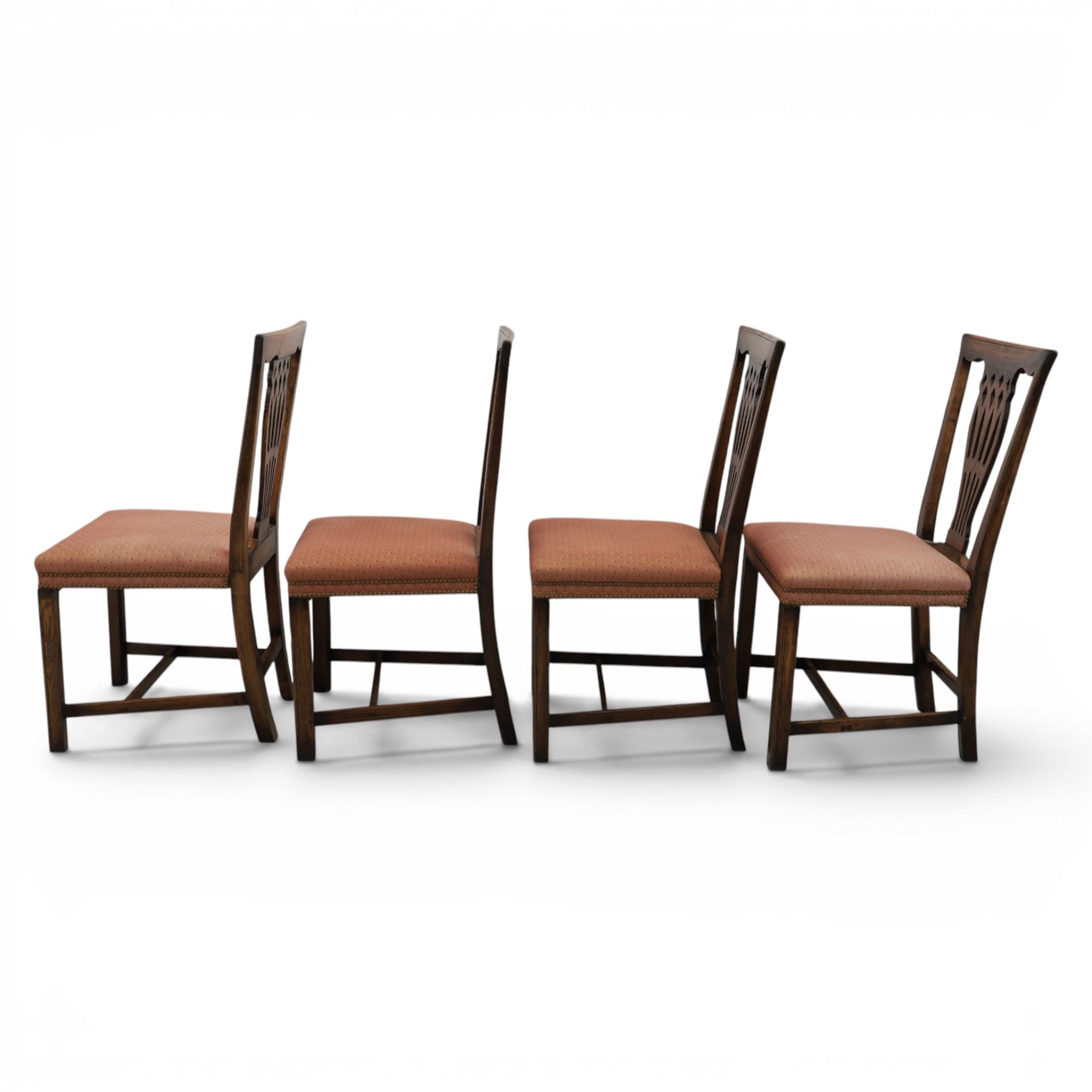 Set of eight George III dining chairs with padded seats, pierced vasiform splat, upholstered seat with brass trim, on square supports with H-stretcher